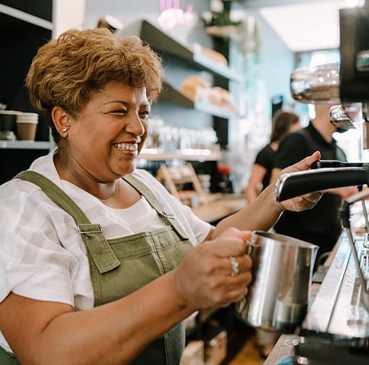 woman making coffee at coffee shop