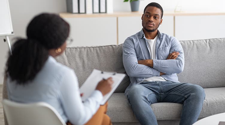 Man on couch with physician