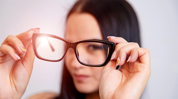 Woman with glasses - when to see a rheumatologist