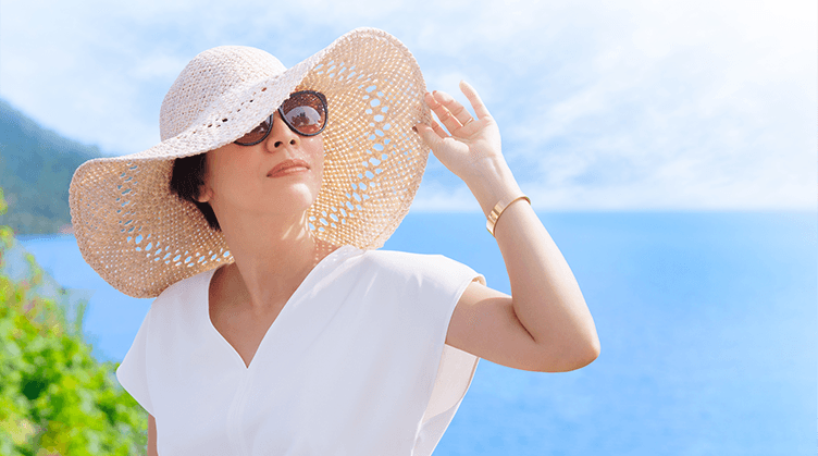 woman wearing a hat looking at sky